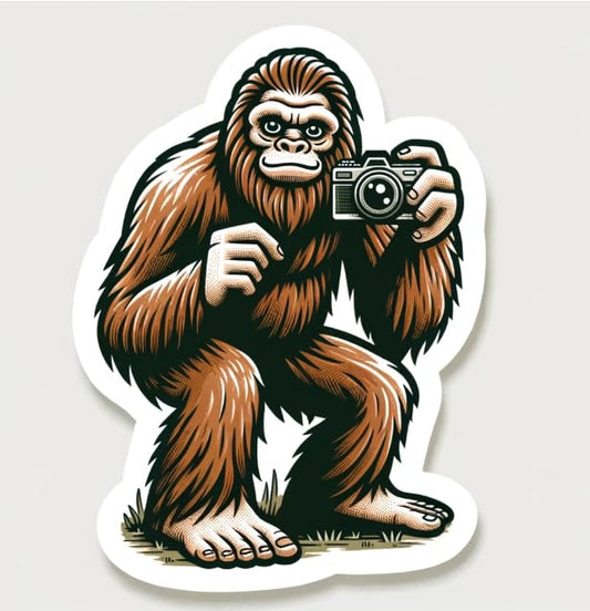Vinyl sticker: Sasquatch Selfie Sticker - Cartoon Bigfoot with Camera Decal for Outdoor Enthusiasts and Mythology Fans