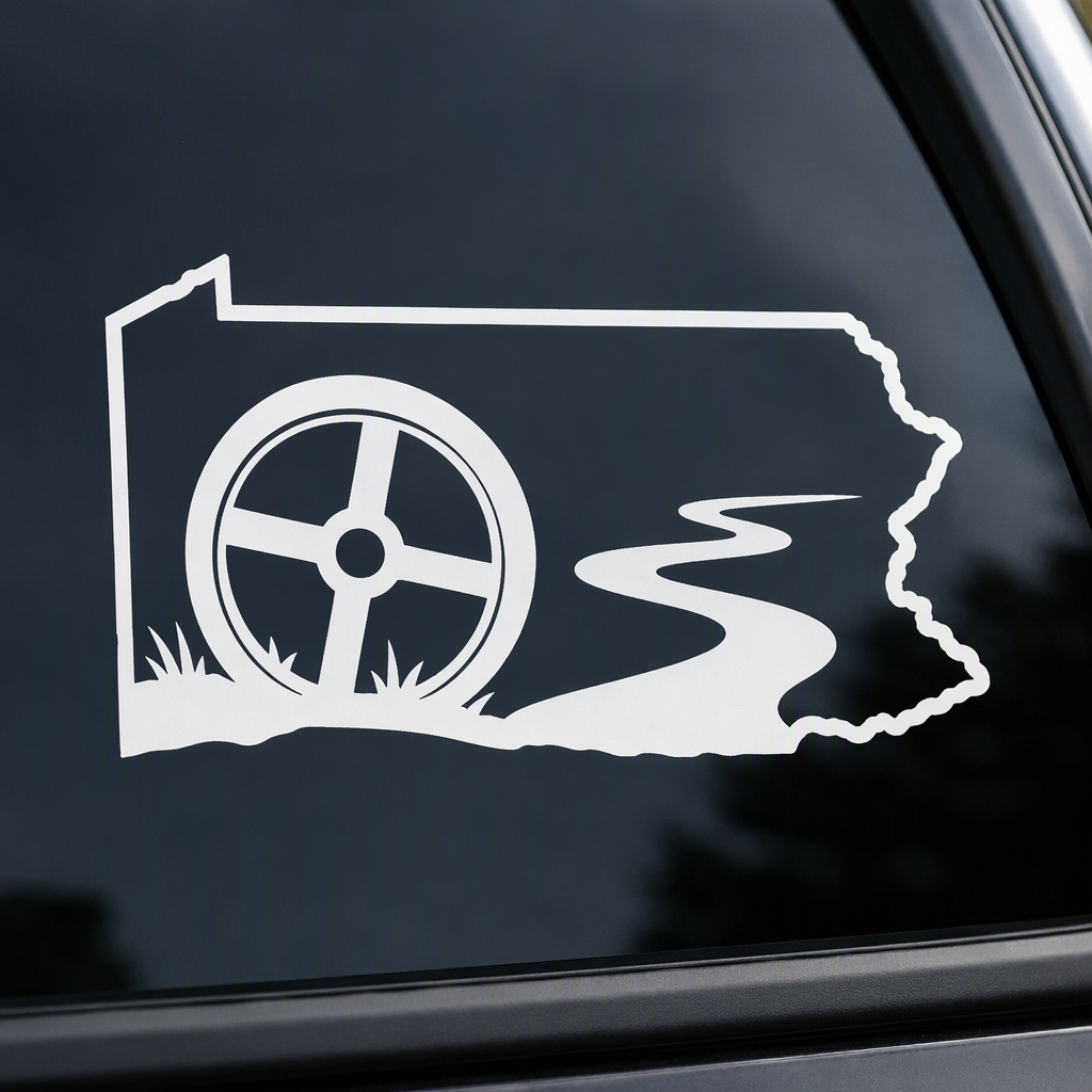 Set within a broad Pennsylvania mainland outline, a covered wagon wheel and river bend create a crisp white decal with a nostalgic backroad-history feel.