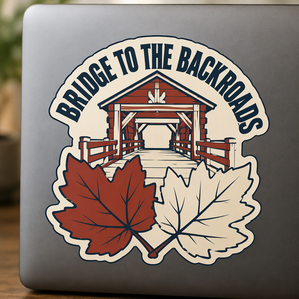 “BRIDGE TO THE BACKROADS” stands above a plain timber bridge framed by two broad autumn leaves, creating an inviting rustic scene for travelers who prefer scenic routes and quiet outdoor escapes.