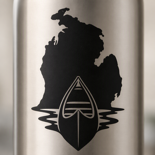 A broad black canoe bow rests against the recognizable outline of Michigan’s Lower Peninsula, with two curved water cutouts preserving a clean lake-inspired look.