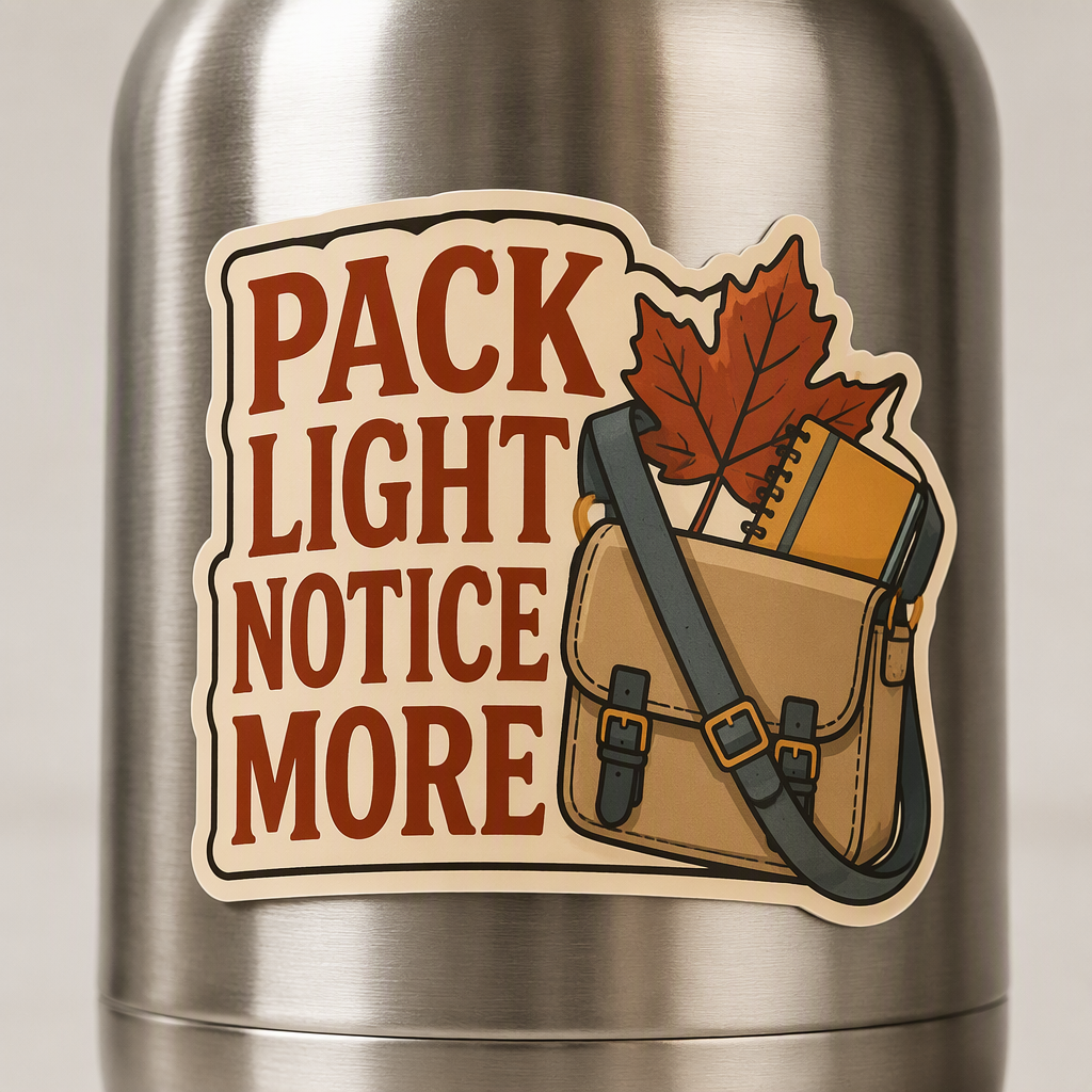 “PACK LIGHT NOTICE MORE” appears in clean rust lettering beside a small walking satchel holding a broad autumn leaf and plain field notebook.